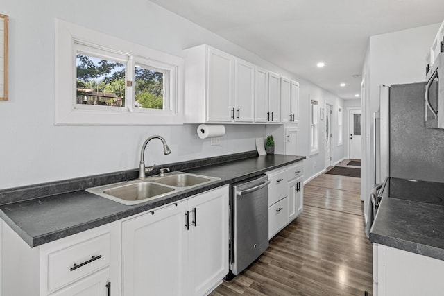 706 2nd Ave NW, New Brighton, MN 55112 - kitchen featuring appliances with stainless steel finishes, dark countertops, recessed lighting, white cabinets, and dark wood finished floors