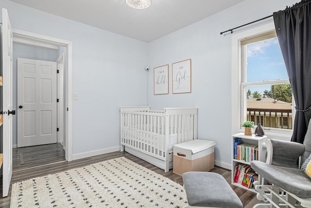 706 2nd Ave NW, New Brighton, MN 55112 - bedroom featuring wood finished floors and a crib