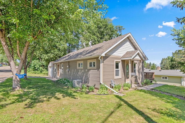 706 2nd Ave NW, New Brighton, MN 55112 - view of home's exterior with a yard and roof with shingles