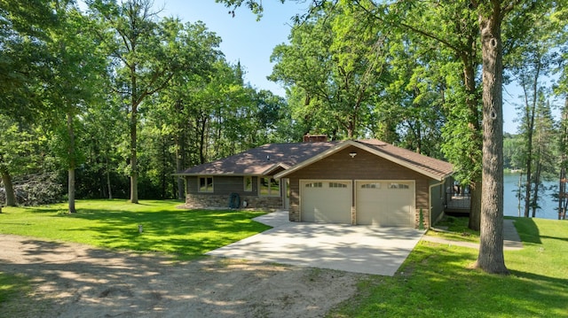 11100 Fisher Ln, Park Rapids, MN 56470 - view of front of property featuring driveway, a front yard, a garage, a chimney, and stone siding