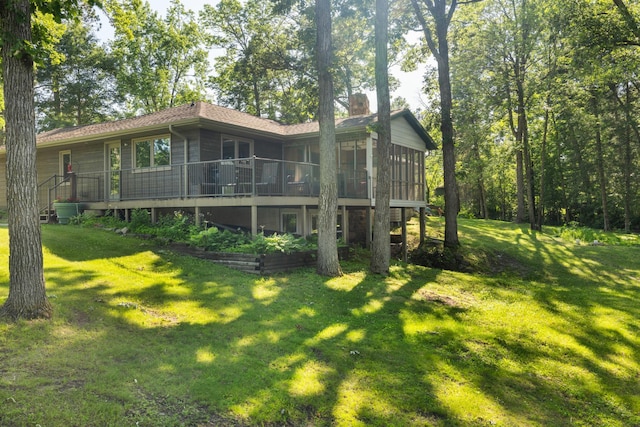 11100 Fisher Ln, Park Rapids, MN 56470 - rear view of house with a sunroom, a yard, and a chimney