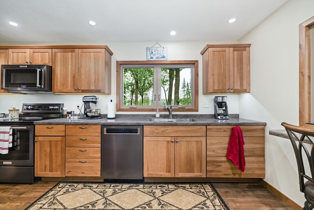 11100 Fisher Ln, Park Rapids, MN 56470 - kitchen with appliances with stainless steel finishes, wood finished floors, dark countertops, and recessed lighting