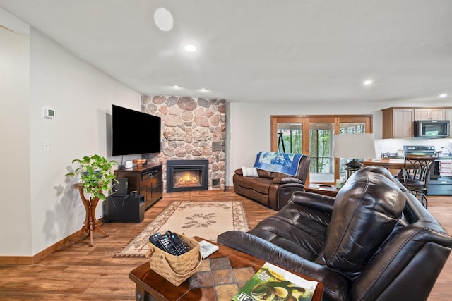 11100 Fisher Ln, Park Rapids, MN 56470 - living area with light wood-style floors, a stone fireplace, and recessed lighting