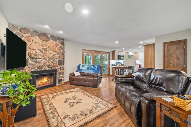 11100 Fisher Ln, Park Rapids, MN 56470 - living room featuring a stone fireplace, light wood-style floors, and recessed lighting
