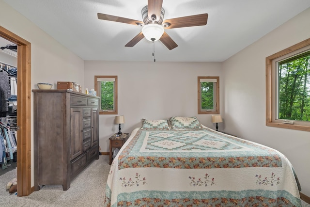 11100 Fisher Ln, Park Rapids, MN 56470 - bedroom featuring light colored carpet, a spacious closet, ceiling fan, and a closet