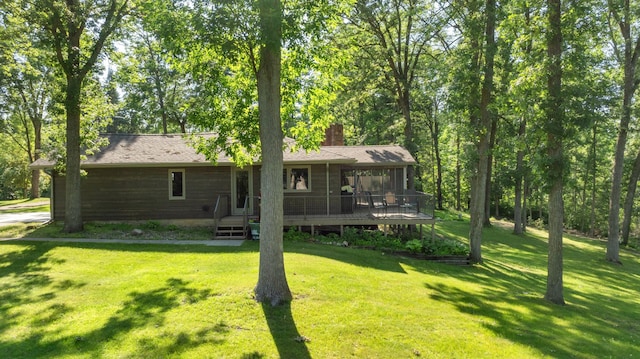 11100 Fisher Ln, Park Rapids, MN 56470 - back of property with a chimney, a lawn, and a deck