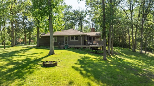 11100 Fisher Ln, Park Rapids, MN 56470 - rear view of property featuring a chimney, a lawn, and a deck
