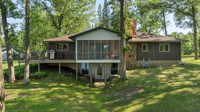 11100 Fisher Ln, Park Rapids, MN 56470 - rear view of house with a sunroom, a chimney, a yard, a deck, and a shingled roof