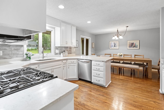 6721 Limerick Ln, Edina, MN 55439 - kitchen with stainless steel dishwasher, a peninsula, white cabinetry, a textured ceiling, and backsplash