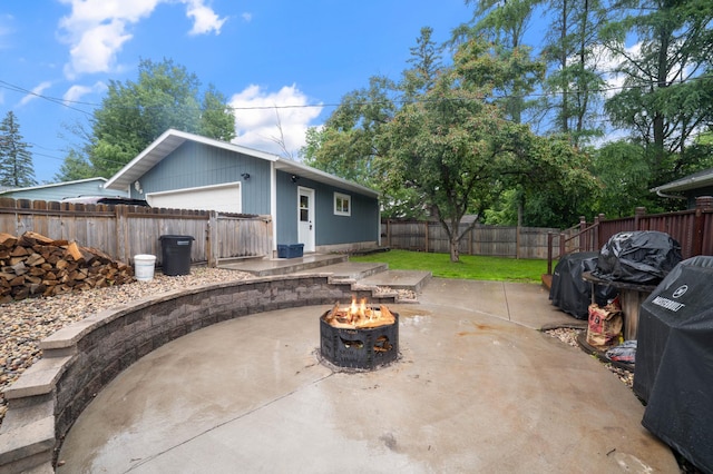 311 70th Ave W, Duluth, MN 55807 - fenced backyard with an outdoor fire pit, a patio, and a detached garage