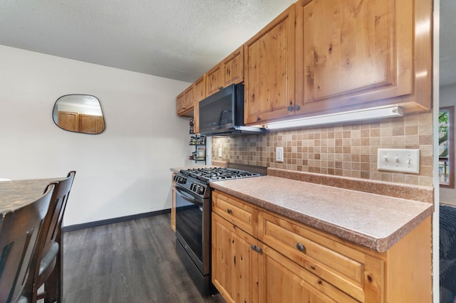 311 70th Ave W, Duluth, MN 55807 - kitchen with stainless steel gas range oven, black microwave, dark wood-style flooring, decorative backsplash, and light countertops