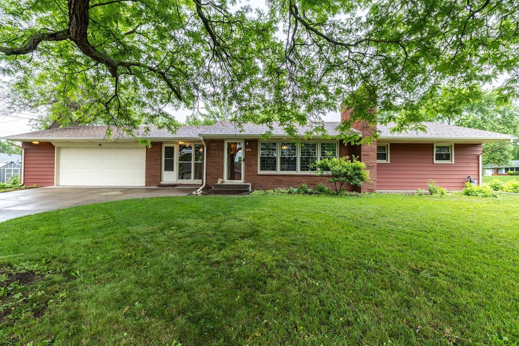 3890 Van Dyke St, White Bear Lake, MN 55110 - single story home featuring an attached garage, concrete driveway, a front yard, a chimney, and brick siding