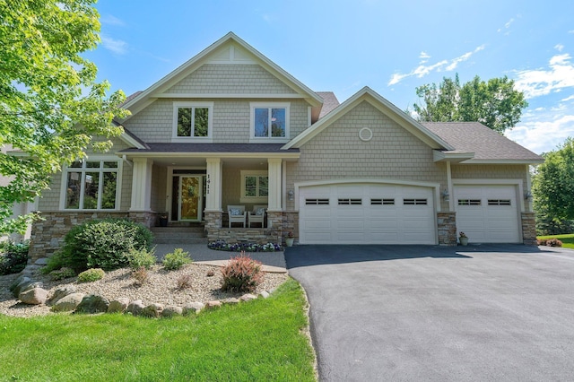 1411 Archwood Rd, Minnetonka, MN 55305 - craftsman inspired home with stone siding, asphalt driveway, and an attached garage