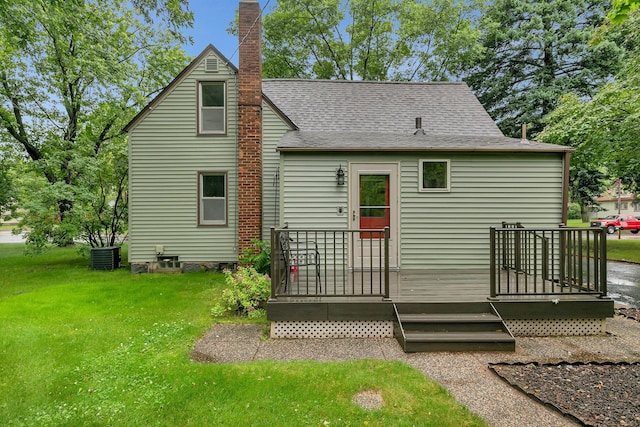 608 Summit Ave S, Sauk Rapids, MN 56379 - rear view of house featuring a chimney, a lawn, a deck, and a shingled roof