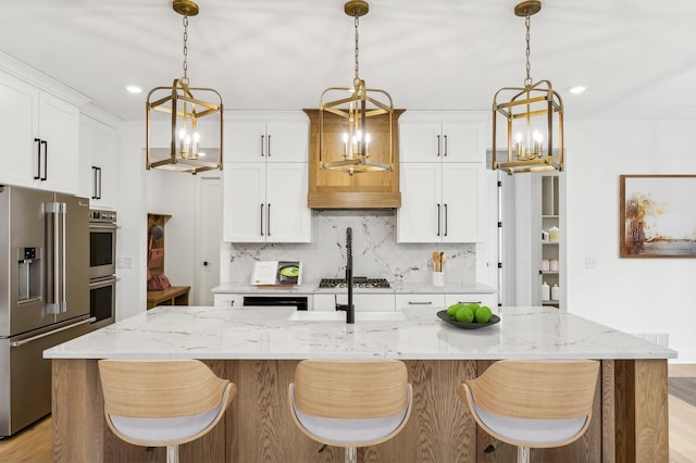 20122 63rd Ave, Corcoran, MN 55340 - kitchen featuring appliances with stainless steel finishes, a chandelier, decorative backsplash, white cabinets, and recessed lighting
