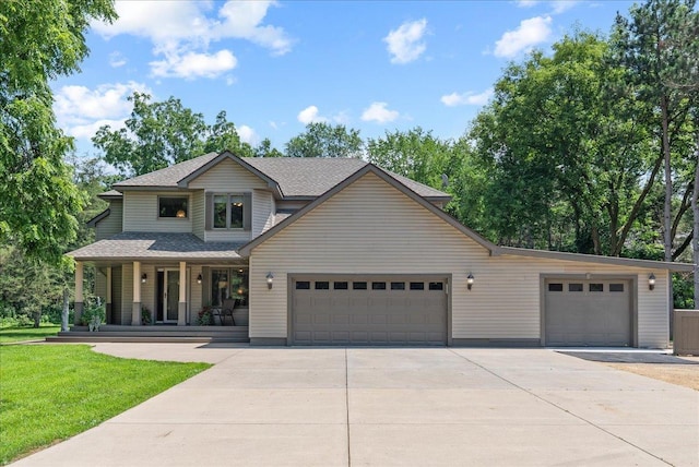 N6386 1317th St, Clifton Twp, WI 54021 - view of front of home featuring driveway, covered porch, a garage, and a front lawn