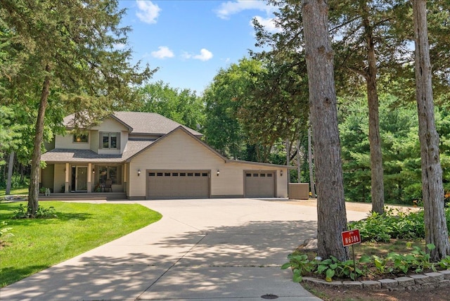 N6386 1317th St, Clifton Twp, WI 54021 - view of front facade with driveway, an attached garage, covered porch, a front yard, and a shingled roof