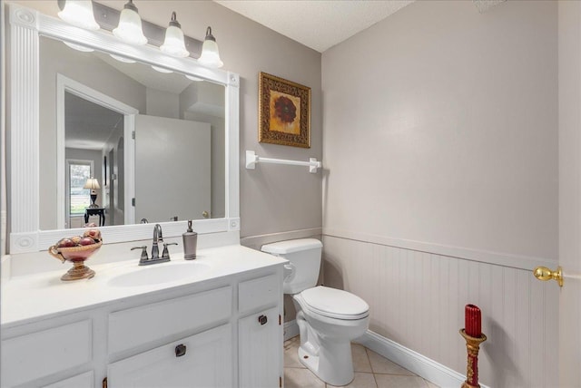 N6386 1317th St, Clifton Twp, WI 54021 - half bathroom featuring a wainscoted wall, vanity, and tile patterned floors