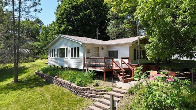 2890 216th St, Laketown Twp, WI 54853 - rear view of house with a yard, a deck, and roof with shingles