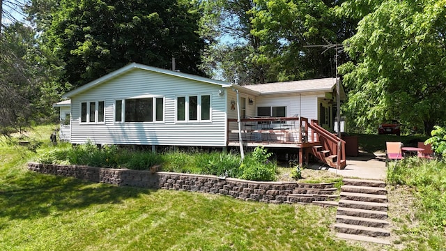 2890 216th St, Laketown Twp, WI 54853 - back of property with a wooden deck, stairs, and a lawn