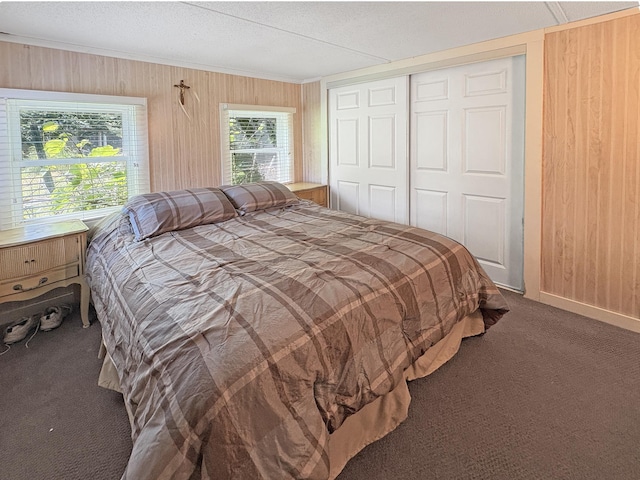 2890 216th St, Laketown Twp, WI 54853 - bedroom featuring carpet floors, wood walls, a closet, a textured ceiling, and ornamental molding