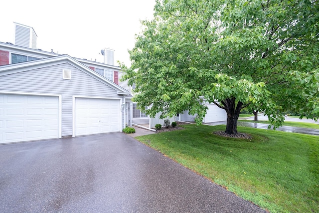 4316 Meghan Ln Unit 402, Eagan, MN 55122 - view of front facade featuring asphalt driveway, a front yard, and a chimney