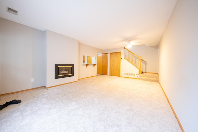 4316 Meghan Ln Unit 402, Eagan, MN 55122 - unfurnished living room with light carpet, stairway, a glass covered fireplace, and ceiling fan