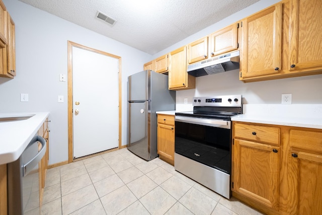 4316 Meghan Ln Unit 402, Eagan, MN 55122 - kitchen featuring under cabinet range hood, appliances with stainless steel finishes, light countertops, a textured ceiling, and light tile patterned flooring