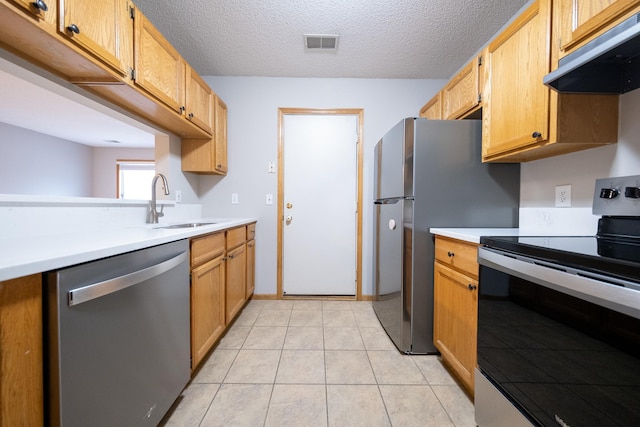 4316 Meghan Ln Unit 402, Eagan, MN 55122 - kitchen featuring appliances with stainless steel finishes, range hood, light countertops, a textured ceiling, and light tile patterned floors