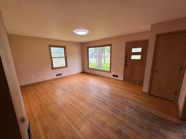 2100 14th St SE, Rochester, MN 55904 - unfurnished room with light wood finished floors and baseboards