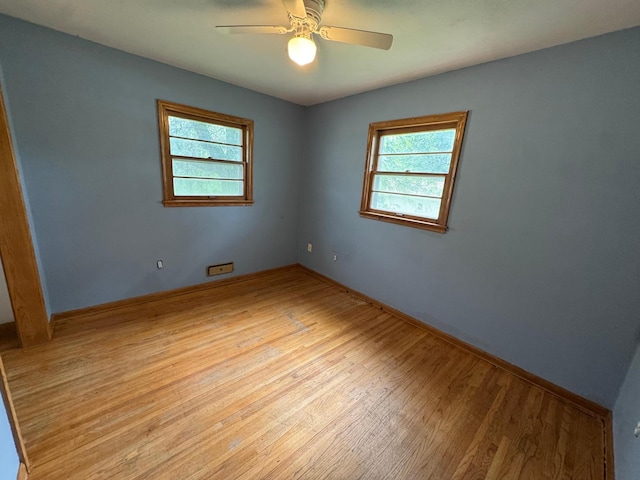 2100 14th St SE, Rochester, MN 55904 - spare room featuring plenty of natural light, wood finished floors, and a ceiling fan