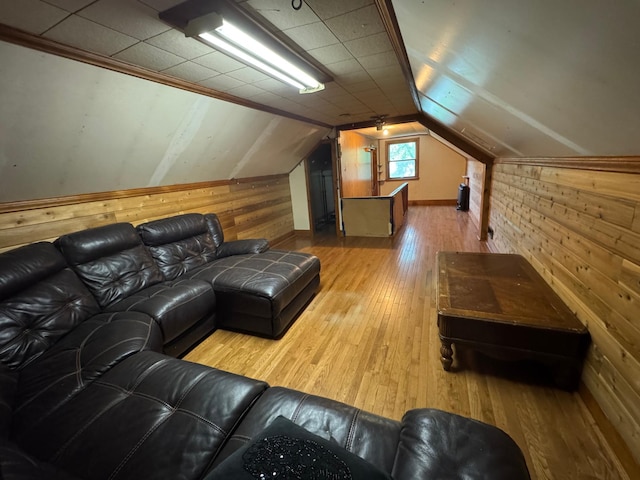 2100 14th St SE, Rochester, MN 55904 - living room featuring wood walls, hardwood / wood-style floors, and vaulted ceiling