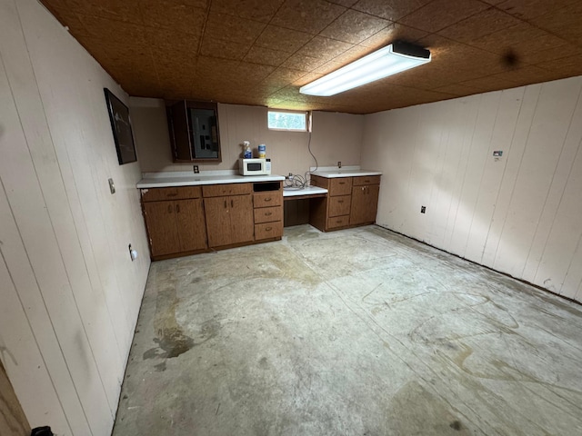 2100 14th St SE, Rochester, MN 55904 - kitchen featuring white microwave, light countertops, brown cabinetry, wooden walls, and electric panel