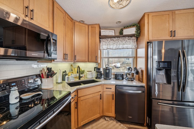 2029 Richardson Ct, Georgetown Twp, WI 54853 - kitchen with stainless steel appliances, light countertops, backsplash, a textured ceiling, and light wood finished floors