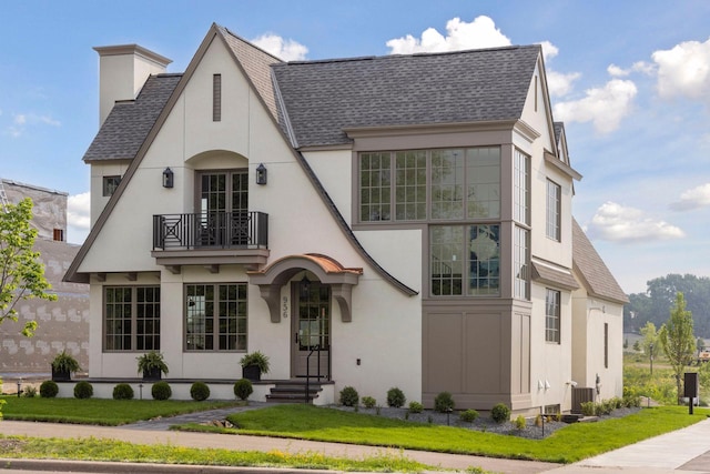956 Mississippi River Blvd S, Saint Paul, MN 55116 - view of front of property featuring a balcony, a shingled roof, stucco siding, and a chimney