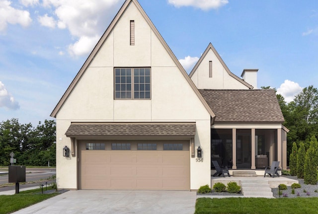 956 Mississippi River Blvd S, Saint Paul, MN 55116 - view of front of home featuring a shingled roof, driveway, a garage, stucco siding, and a sunroom