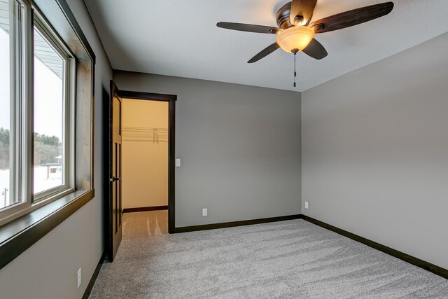 893 Grant St, Ellsworth, WI 54011 - spare room featuring light colored carpet and ceiling fan