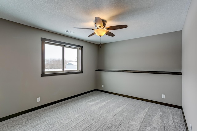 893 Grant St, Ellsworth, WI 54011 - empty room featuring ceiling fan, carpet, and a textured ceiling