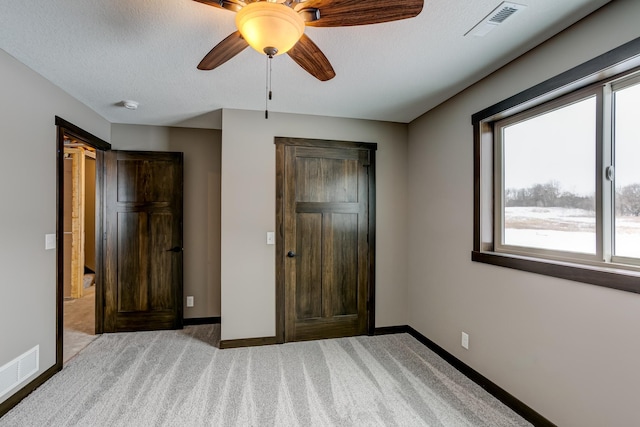 893 Grant St, Ellsworth, WI 54011 - unfurnished bedroom featuring carpet, a ceiling fan, and a textured ceiling