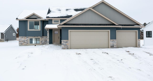 893 Grant St, Ellsworth, WI 54011 - view of front of home with stone siding and an attached garage