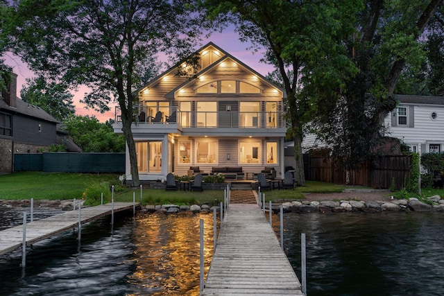 2807 Mckenzie Point Rd, Minnetonka, MN 55391 - back of house at dusk featuring a balcony, a water view, and an outdoor living space