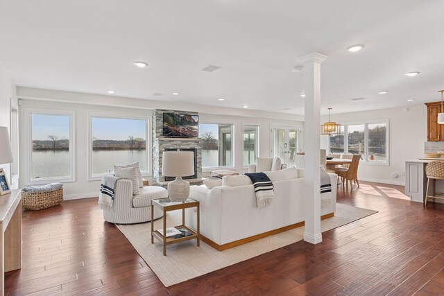 2807 Mckenzie Point Rd, Minnetonka, MN 55391 - living room featuring a fireplace, dark wood-style floors, recessed lighting, and decorative columns