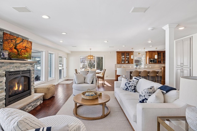 2807 Mckenzie Point Rd, Minnetonka, MN 55391 - living room featuring hardwood / wood-style floors, recessed lighting, a stone fireplace, and decorative columns