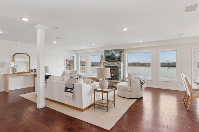 2807 Mckenzie Point Rd, Minnetonka, MN 55391 - living room featuring a fireplace, dark wood-type flooring, recessed lighting, and decorative columns