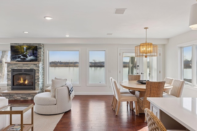 2807 Mckenzie Point Rd, Minnetonka, MN 55391 - dining space with a chandelier, dark wood finished floors, a fireplace, and recessed lighting