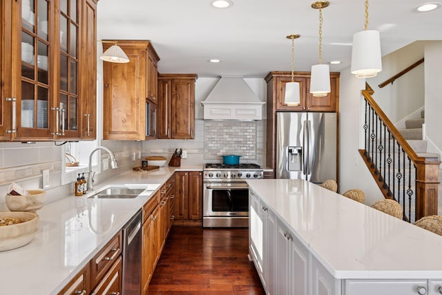 2807 Mckenzie Point Rd, Minnetonka, MN 55391 - kitchen featuring stainless steel appliances, premium range hood, a kitchen island, brown cabinets, and dark wood finished floors