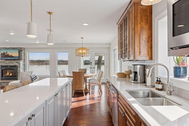 2807 Mckenzie Point Rd, Minnetonka, MN 55391 - kitchen featuring brown cabinets, a fireplace, dark wood-style flooring, pendant lighting, and recessed lighting