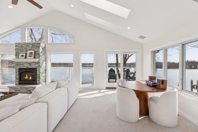 2807 Mckenzie Point Rd, Minnetonka, MN 55391 - dining room featuring a water view, a stone fireplace, recessed lighting, carpet flooring, and high vaulted ceiling