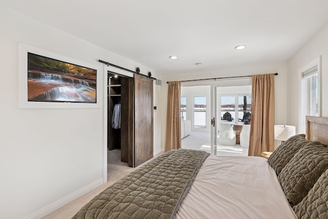 2807 Mckenzie Point Rd, Minnetonka, MN 55391 - bedroom with light colored carpet, a barn door, multiple windows, access to outside, and recessed lighting