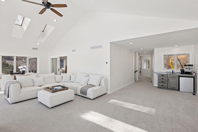 2807 Mckenzie Point Rd, Minnetonka, MN 55391 - living area featuring light carpet, high vaulted ceiling, a ceiling fan, a skylight, and recessed lighting
